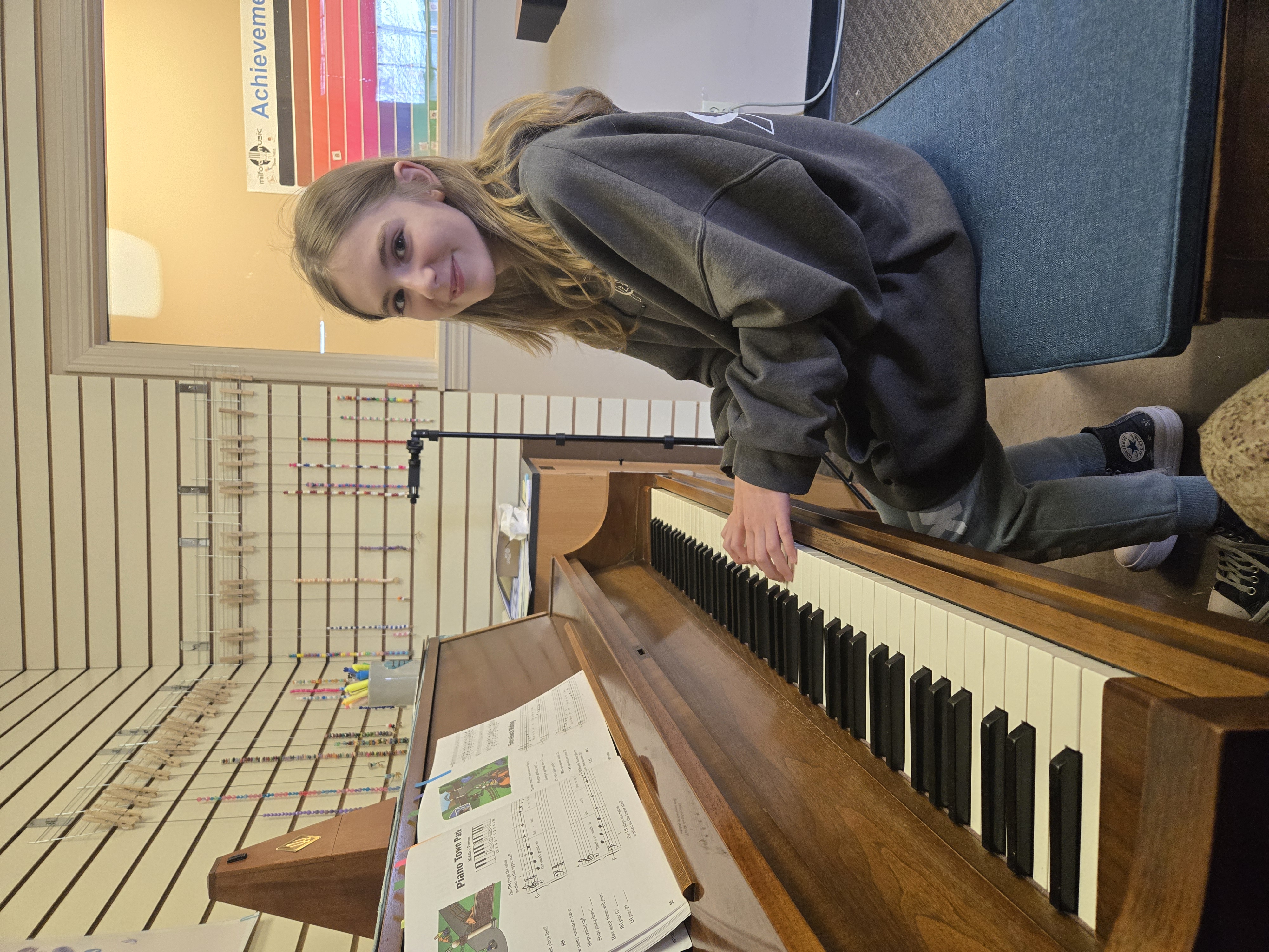 Teacher guiding a piano student during a lesson